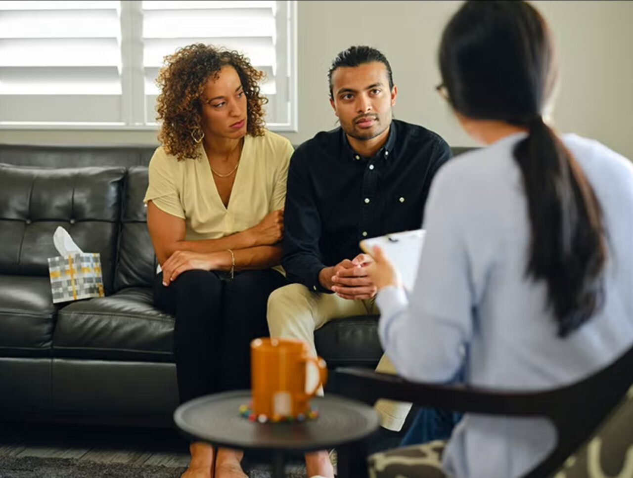 An image showing a couple engaged in a therapy session, reflecting the importance of seeking professional help.